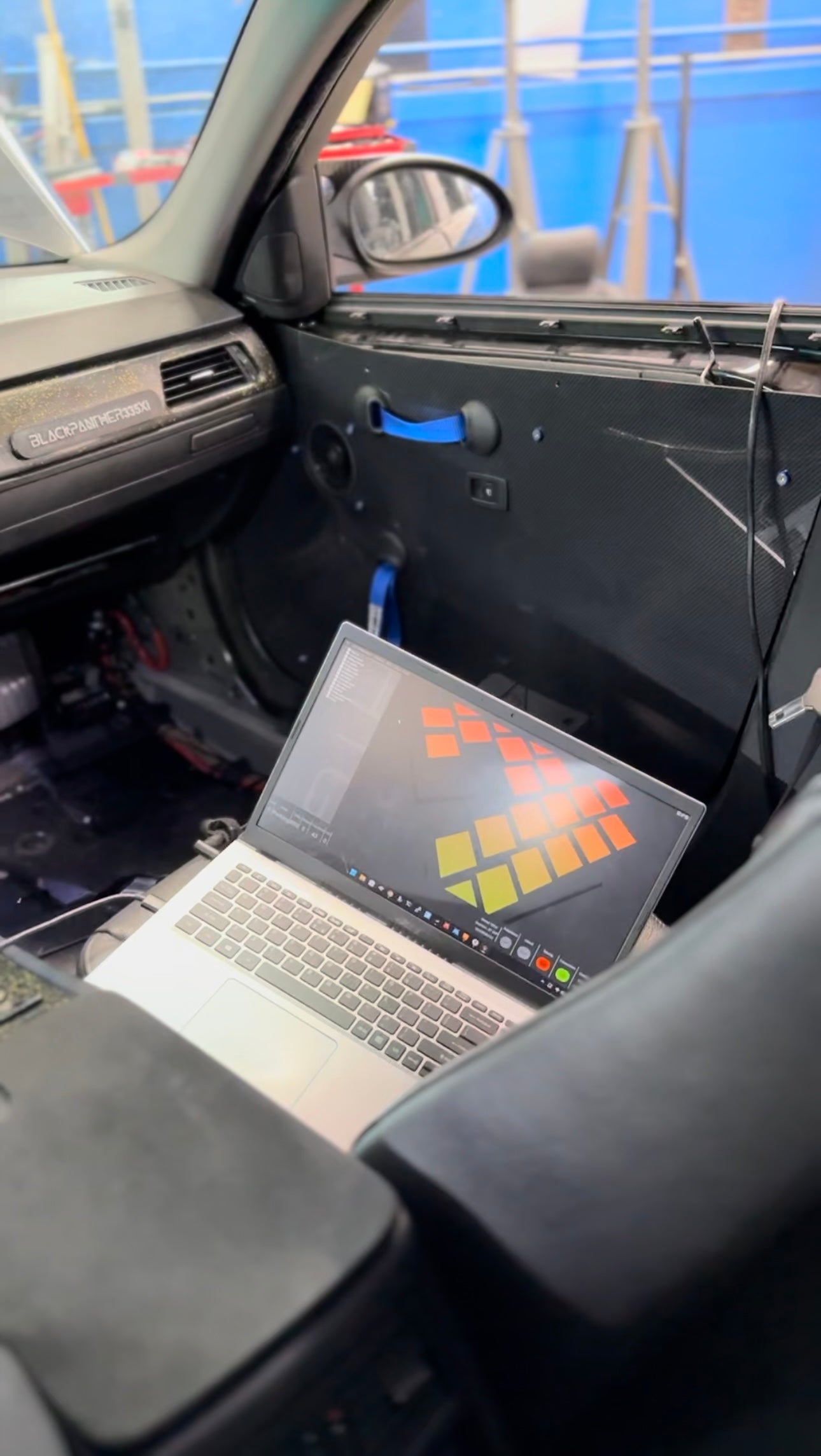 Laptop in car preparing for local car engine and transmission tuning at skreettuners.com